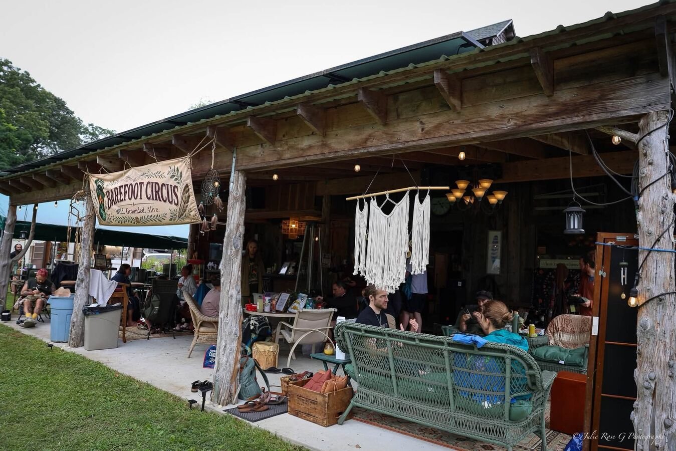 The Barefoot Circus lodge, hung with macramé, open to the lawn